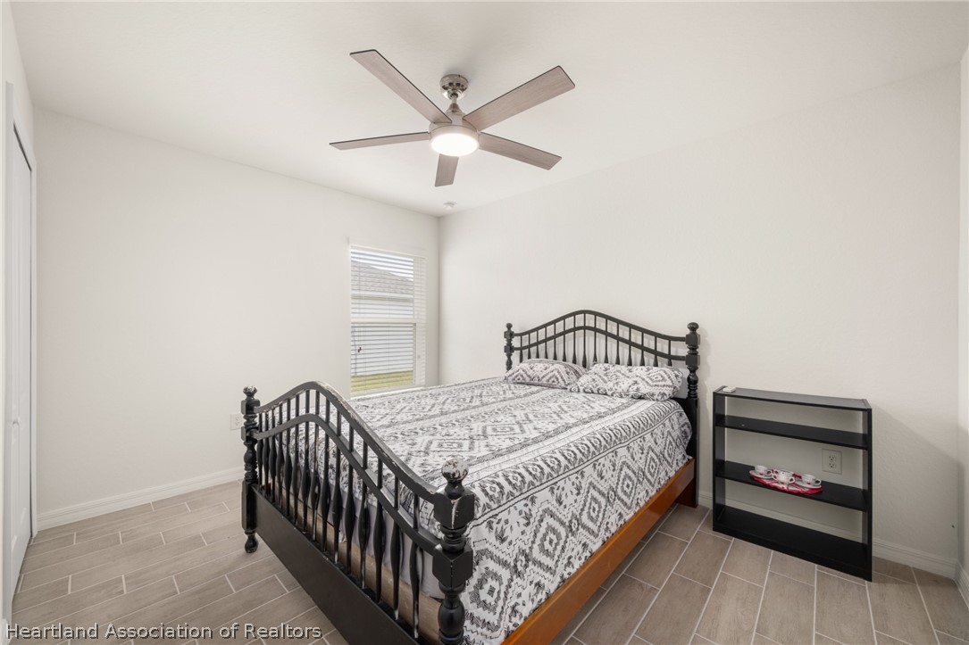 1204 Ridge Drive Avon Park, FL 33825 - Photo 12 of 20 a bedroom with a bed and a chandelier