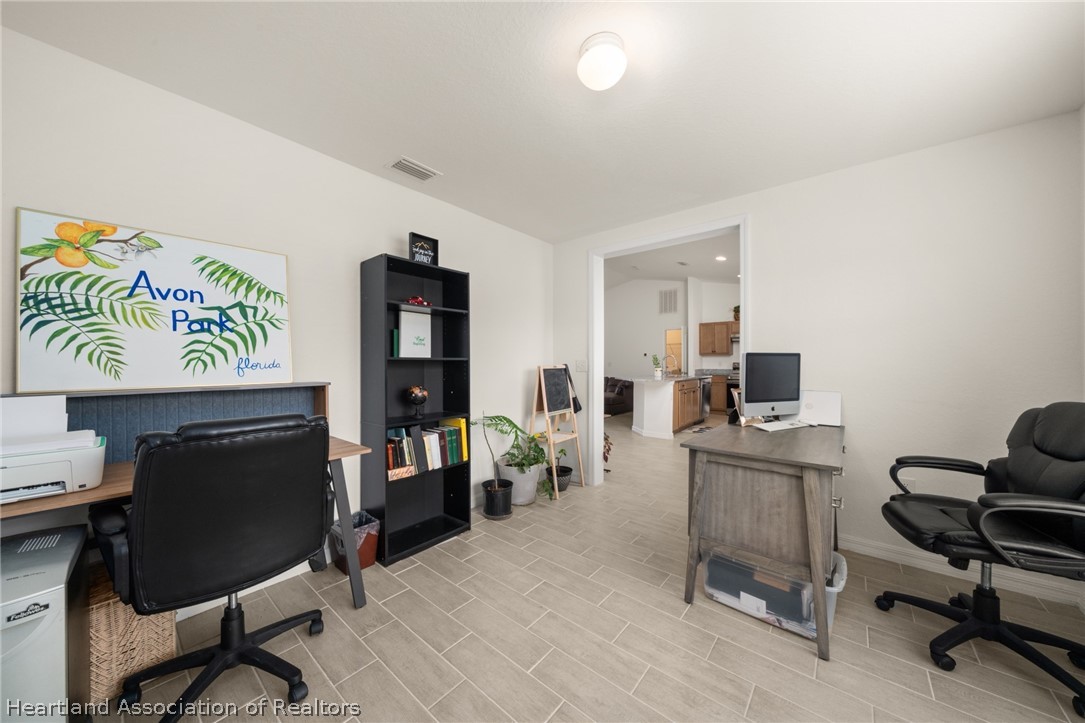 1204 Ridge Drive Avon Park, FL 33825 - Photo 15 of 20 a view of a workspace with furniture and a livingroom