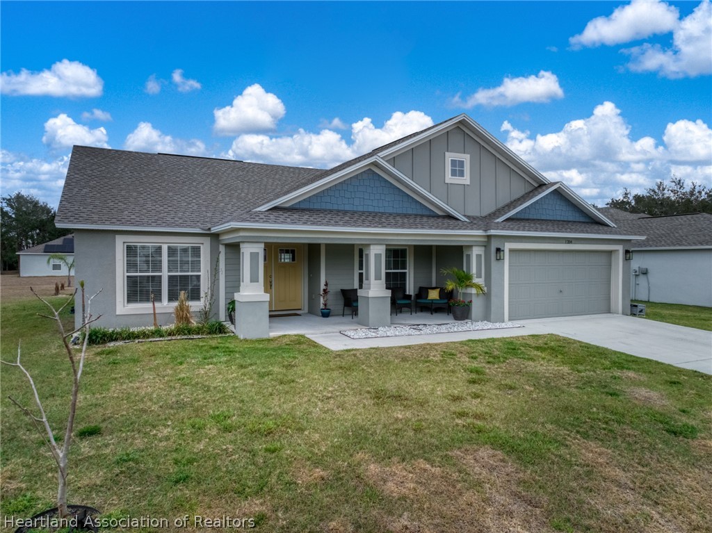 1204 Ridge Drive Avon Park, FL 33825 - Photo 2 of 20 a view of a house with a yard and sitting area