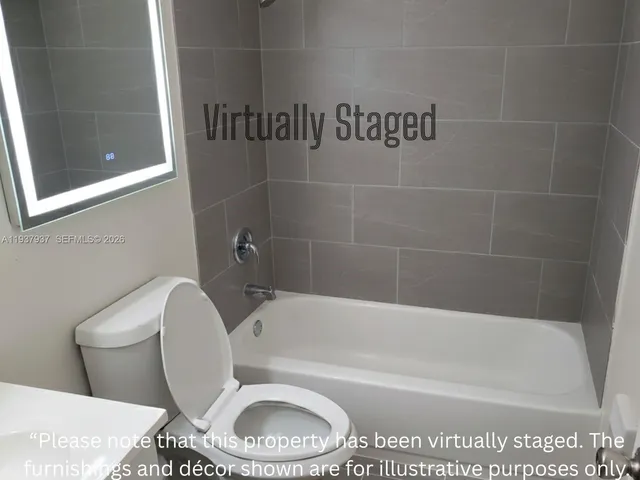 a bathroom with a toilet and a bath tub