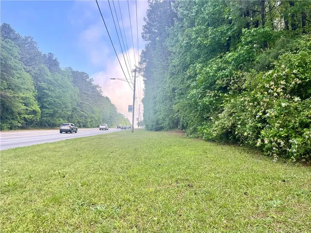 a view of a field of grass and trees