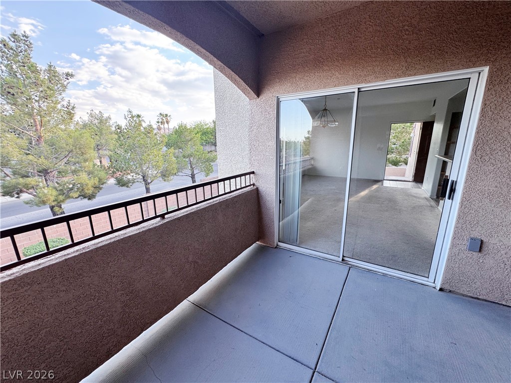 9580 West Reno Avenue, Unit 242 Las Vegas, NV 89148 - Photo 21 of 26 A private balcony offers serene views of mature trees and the peaceful neighborhood.