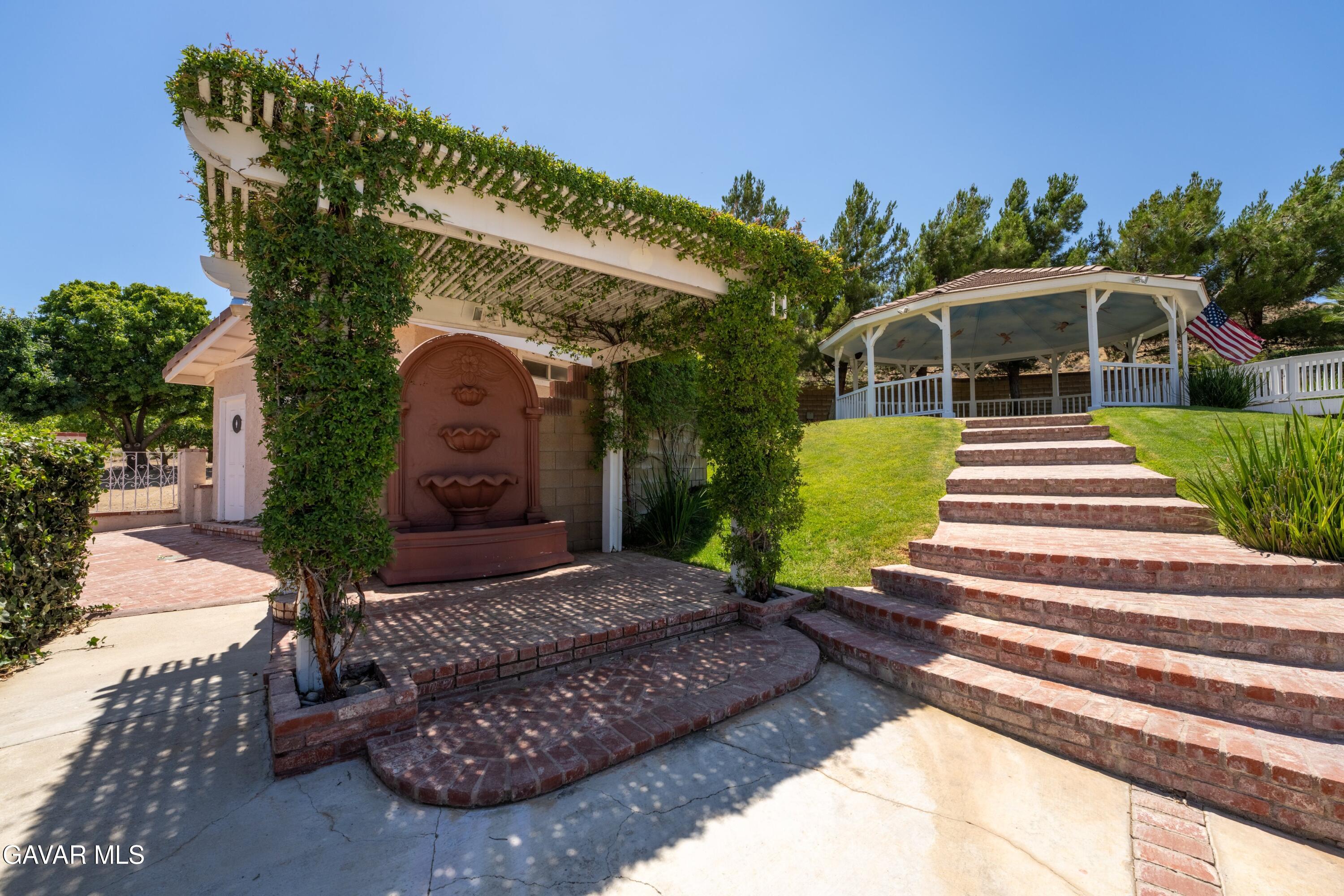 5801 Hacienda Ranch Road Palmdale, CA 93551 - Photo 55 of 69 a front view of a house with garden