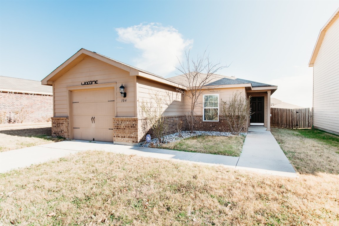 104 Koontz Loop Jarrell, TX 76537 - Photo 1 of 1 a view of a house with a yard and garage
