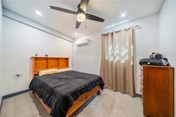 a bedroom with bed and window
