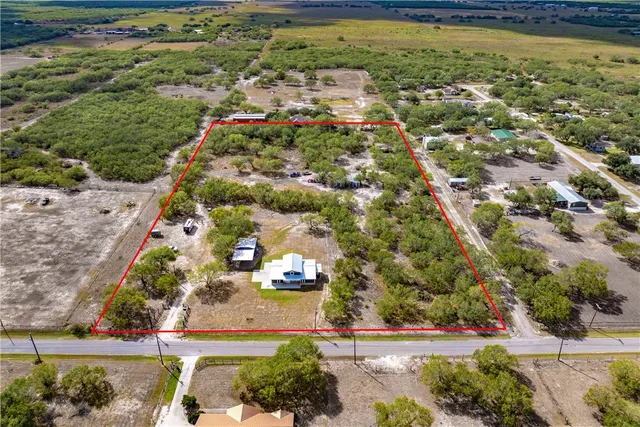 an aerial view of residential houses with outdoor space