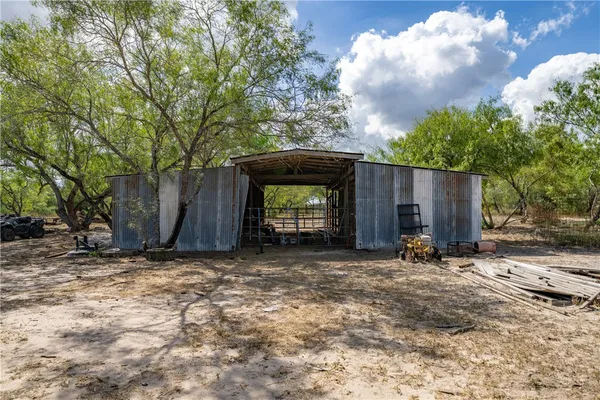 a backyard of a house with table and chairs