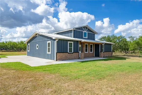 a front view of house with yard and green space