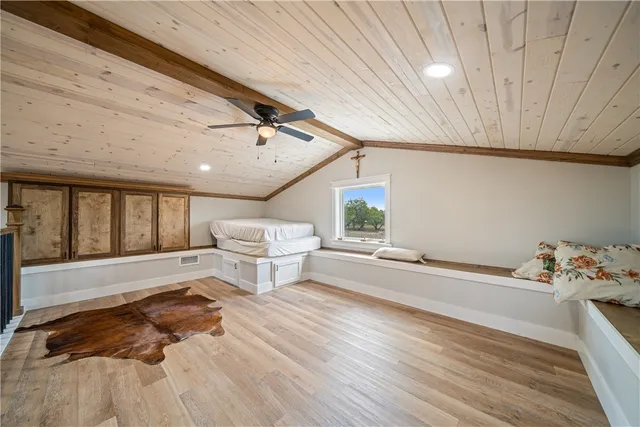 a spacious bedroom with a bed and a window