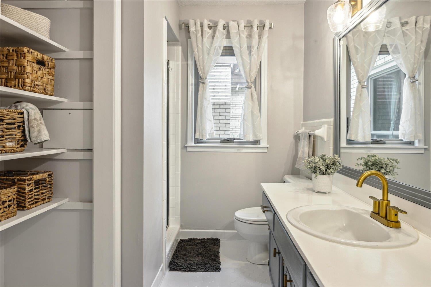 2397 Lynnfield Road Memphis, TN 38119 - Photo 11 of 28 a bathroom with a sink toilet and a mirror