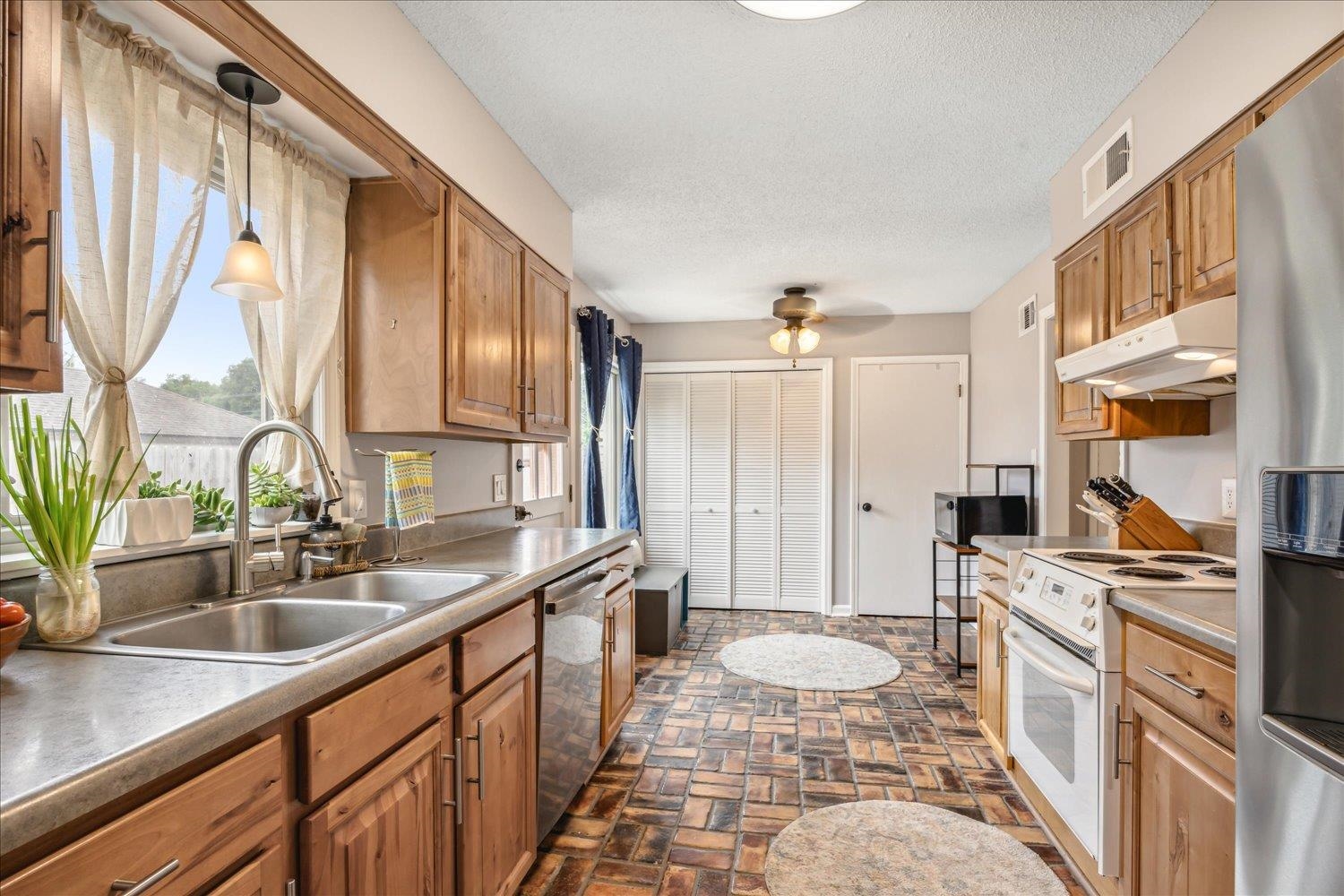 2397 Lynnfield Road Memphis, TN 38119 - Photo 18 of 28 a kitchen with a sink stove and cabinets