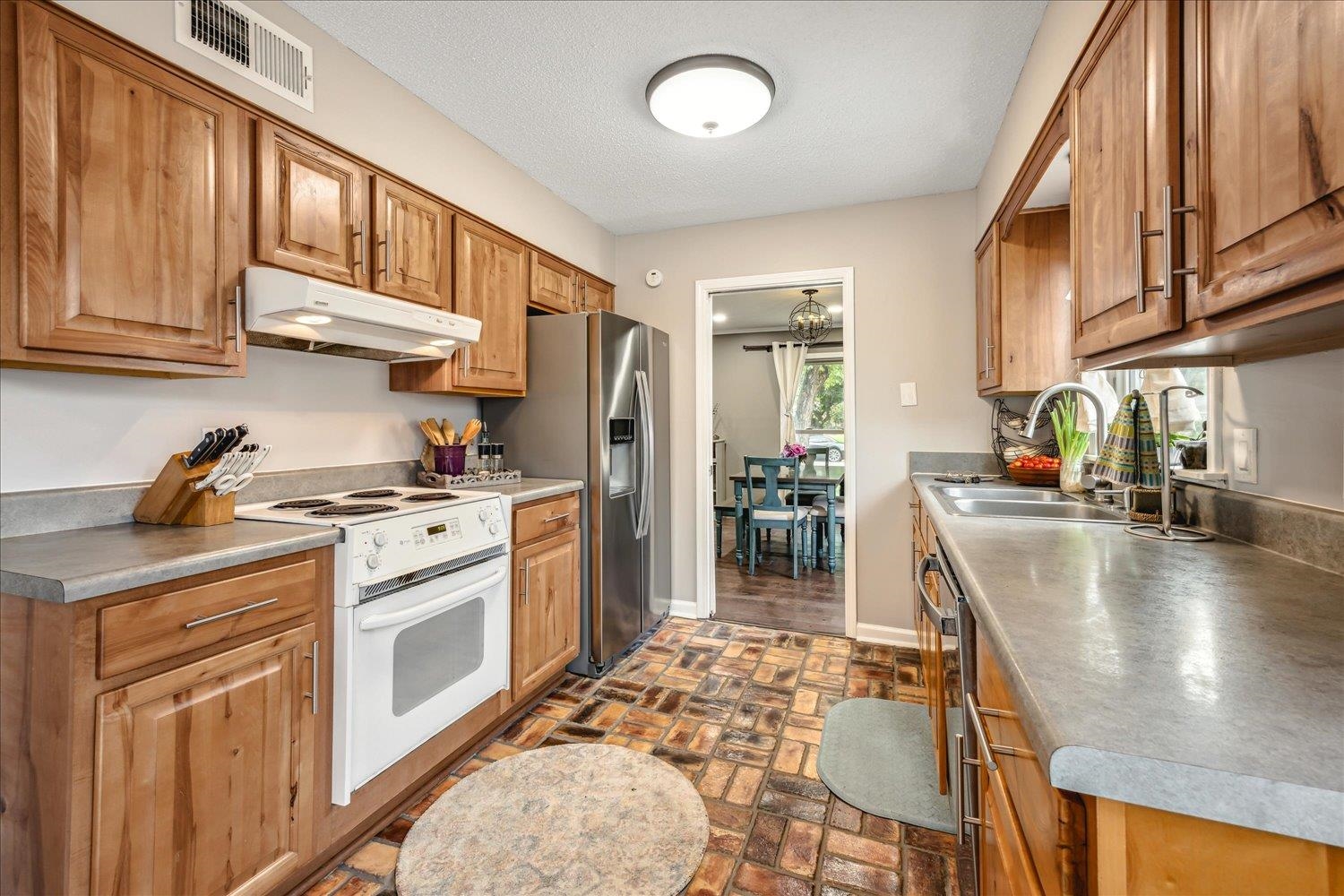 2397 Lynnfield Road Memphis, TN 38119 - Photo 20 of 28 a kitchen with stainless steel appliances granite countertop a refrigerator a stove and a sink with cabinets