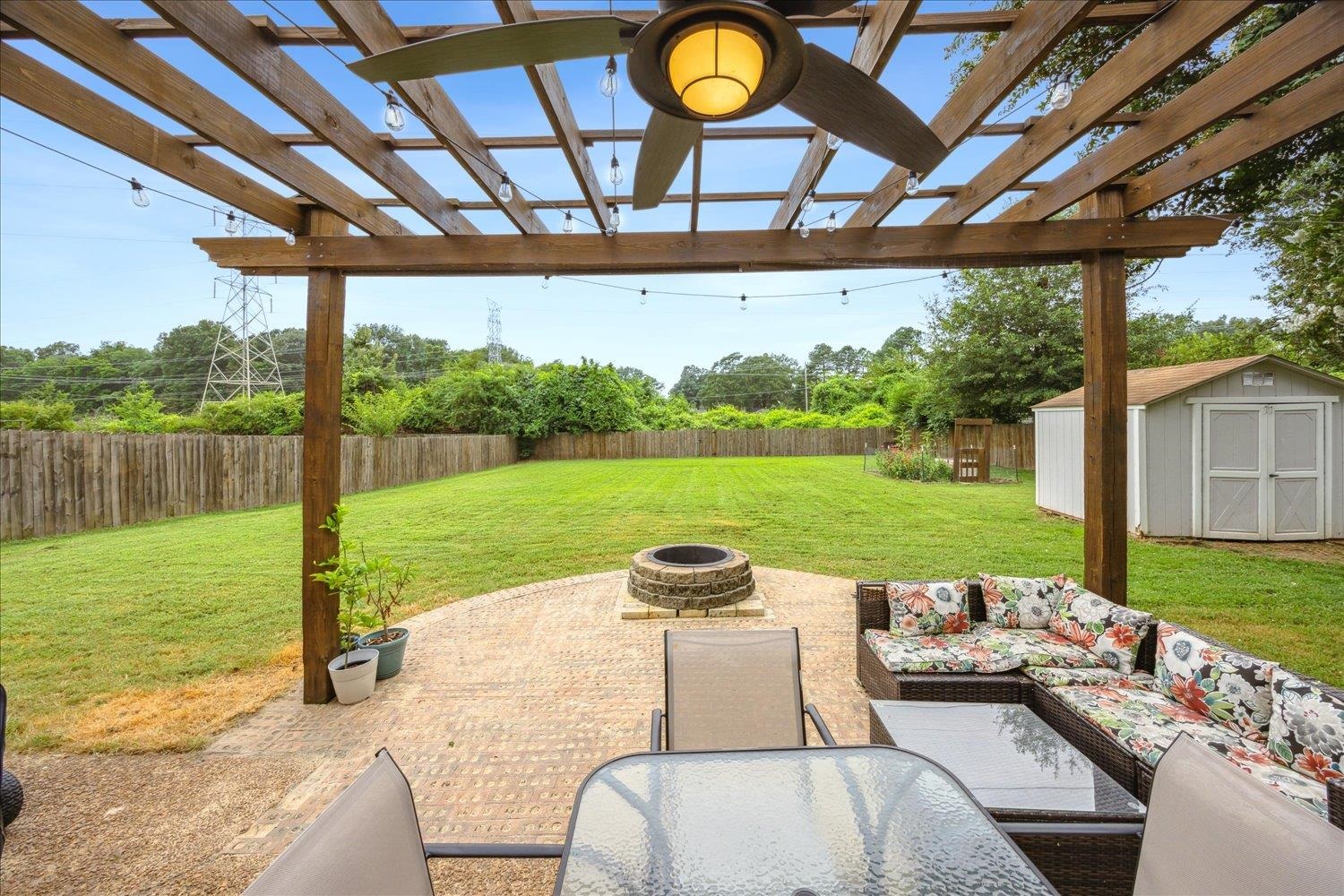2397 Lynnfield Road Memphis, TN 38119 - Photo 23 of 28 a view of a patio with a table chairs and a backyard