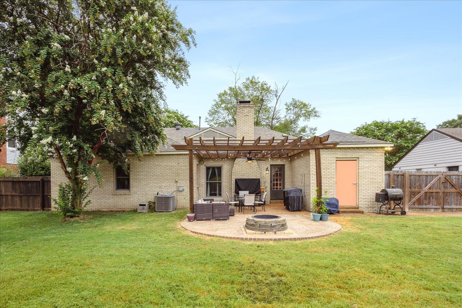 2397 Lynnfield Road Memphis, TN 38119 - Photo 25 of 28 a view of a house with a backyard porch and sitting area