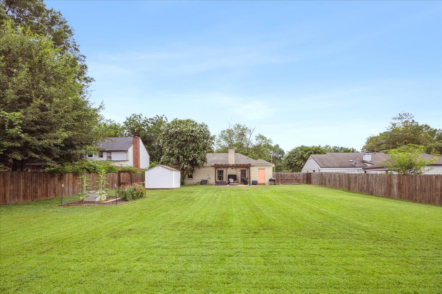 2397 Lynnfield Road Memphis, TN 38119 - Photo 26 of 28 a view of a house with a big yard and large trees