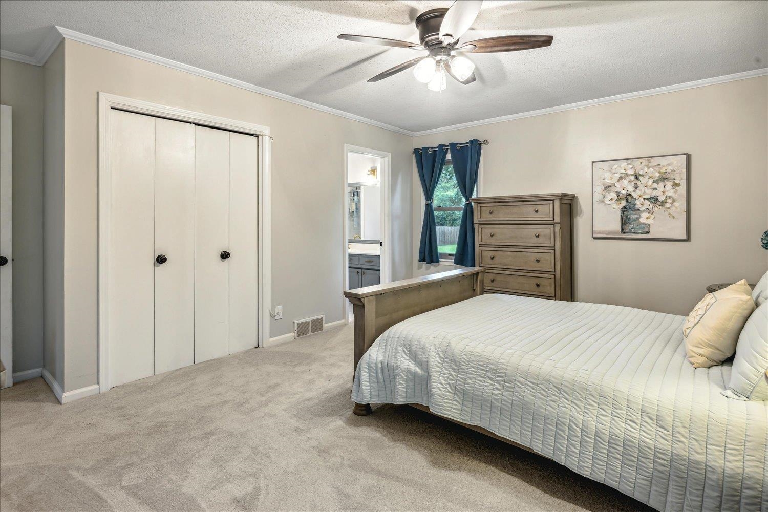 2397 Lynnfield Road Memphis, TN 38119 - Photo 10 of 28 a bedroom with a bed and a chandelier