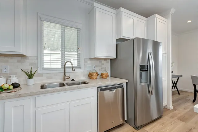 a kitchen with stainless steel appliances white cabinets and a sink