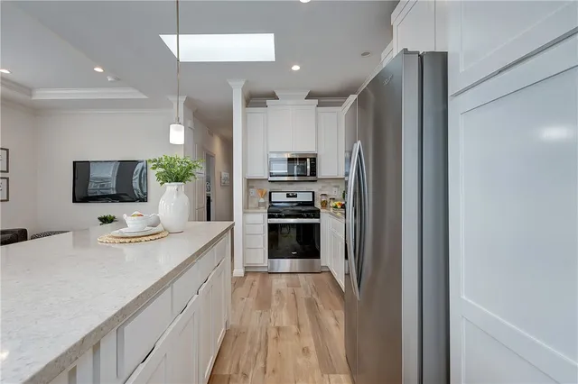 a large kitchen with a large counter top appliances and cabinets
