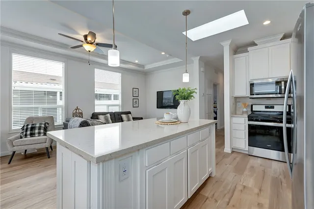 a large white kitchen with a large window