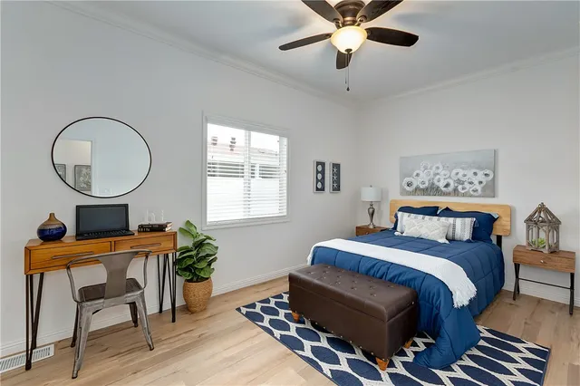 a bedroom with a bed window and a chandelier