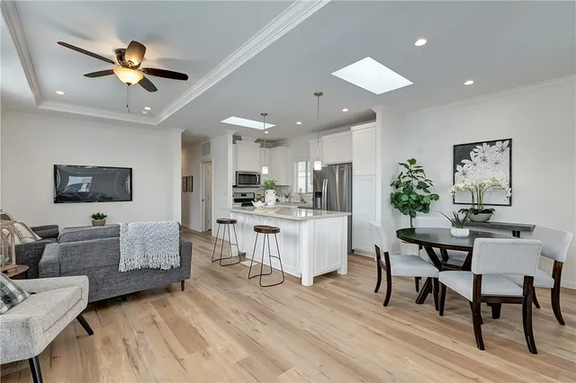 a living room with kitchen island furniture and a ceiling fan