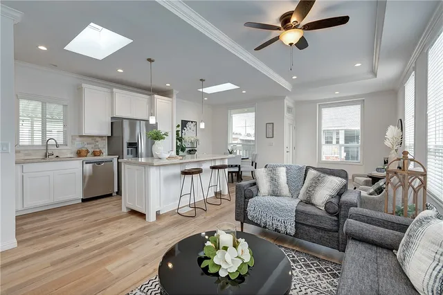 a living room with furniture and kitchen view