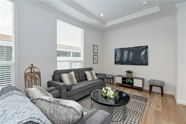 a living room with furniture potted plant and window