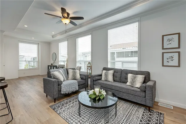 a living room with furniture a table and a large window