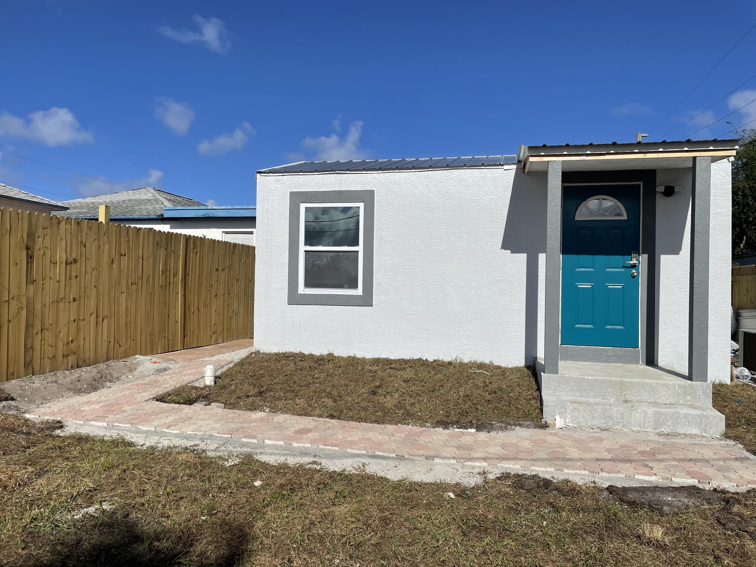 825 West 3rd Street, Unit 4 Riviera Beach, FL 33404 - Photo 1 of 7 a view of backyard with wooden fence