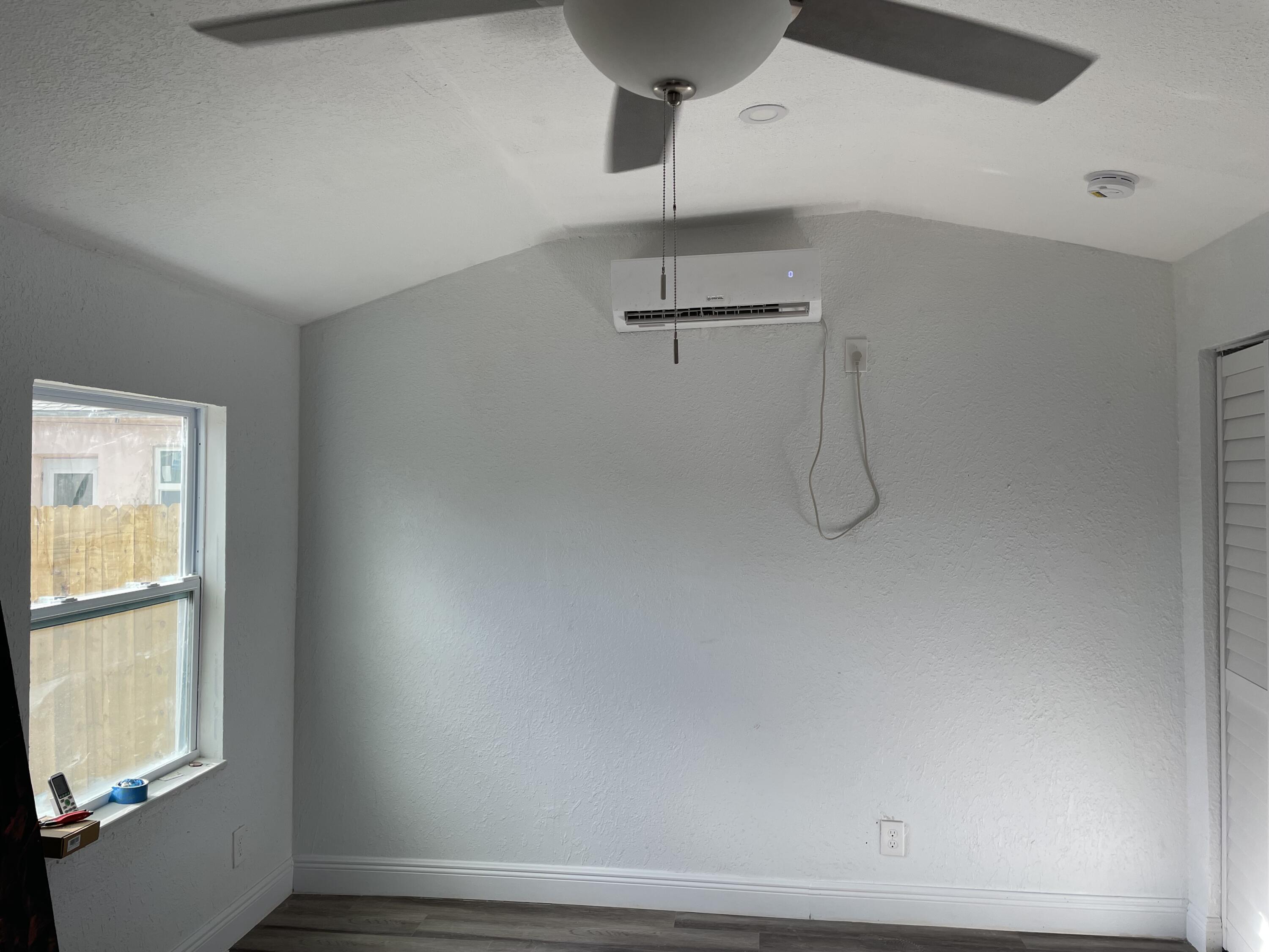 825 West 3rd Street, Unit 4 Riviera Beach, FL 33404 - Photo 3 of 7 a view of a room with rack on the wall and a window