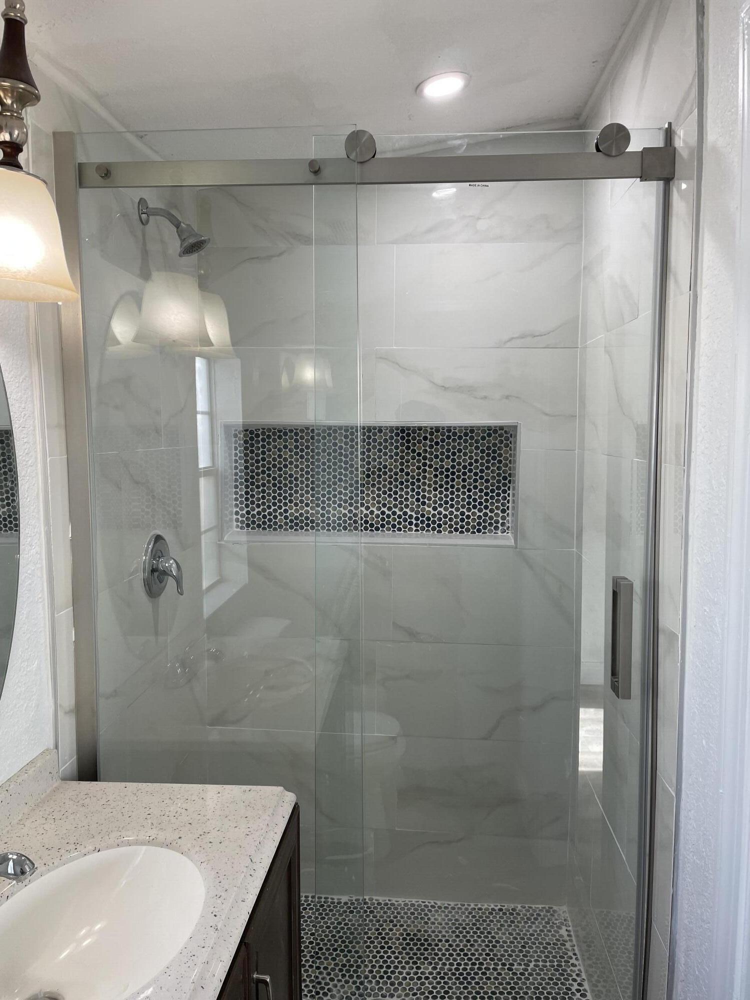 825 West 3rd Street, Unit 4 Riviera Beach, FL 33404 - Photo 4 of 7 a bathroom with a shower and a sink