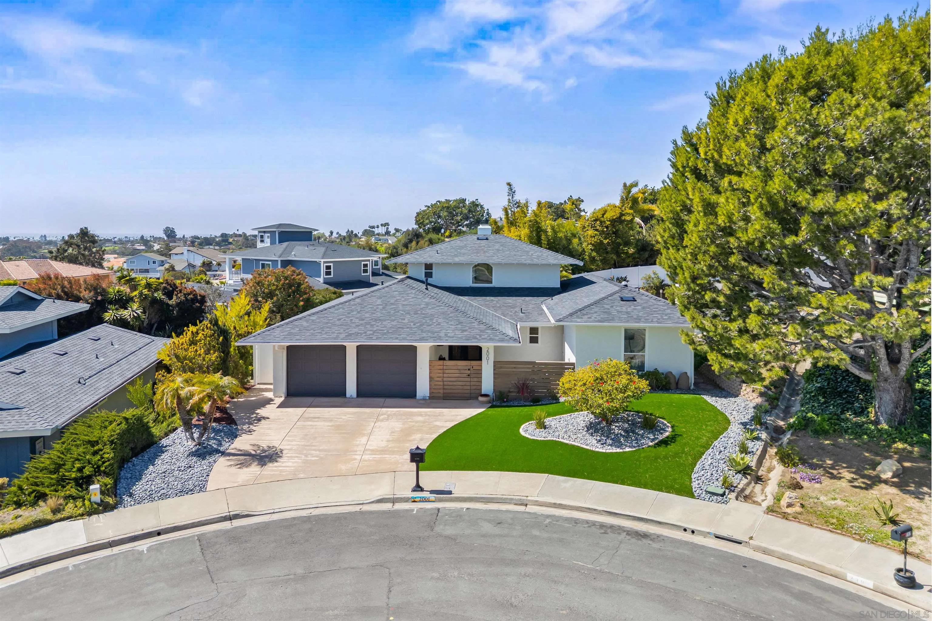 a house with green field in front of it