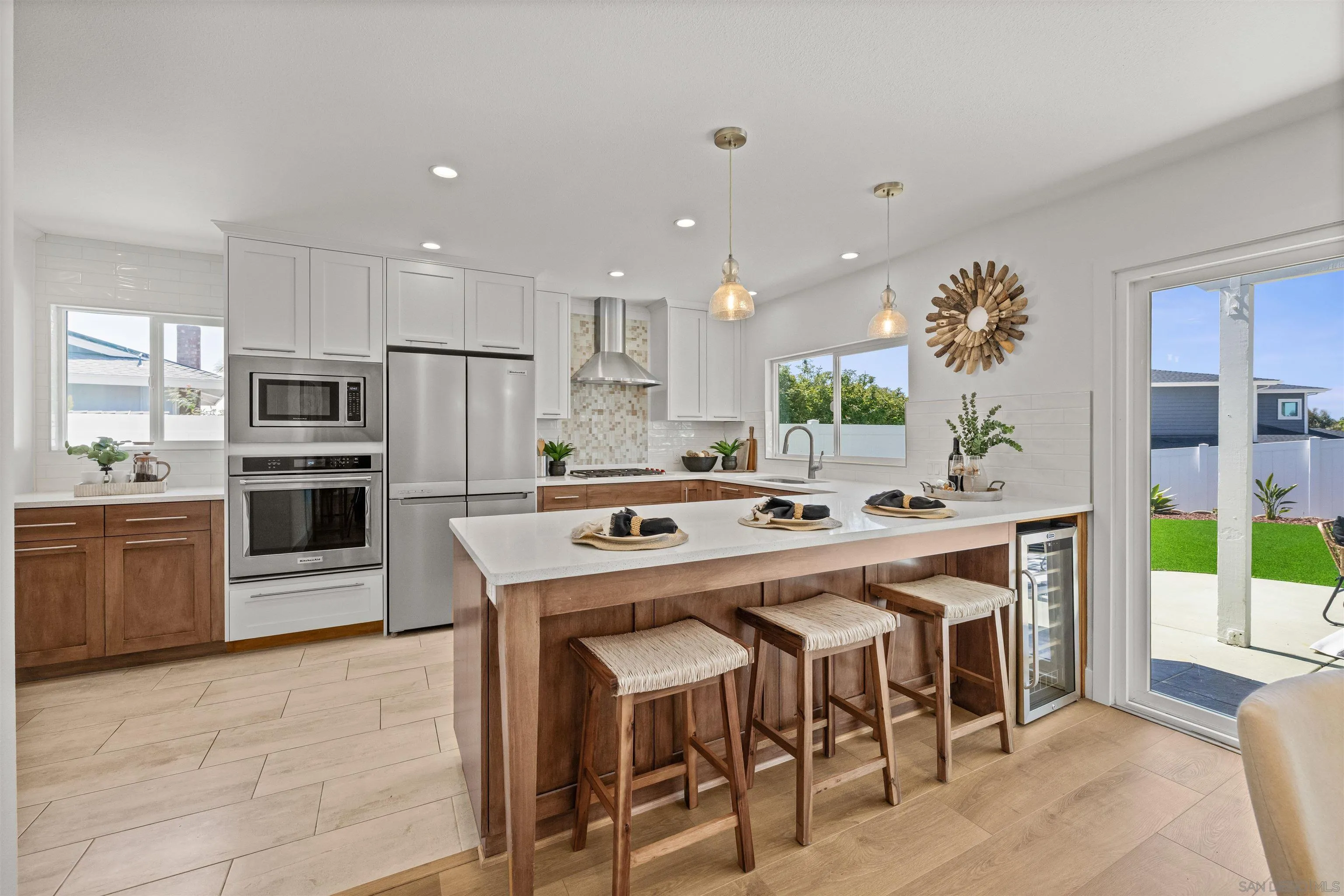 2001 Elevada Street Oceanside, CA 92054 - Photo 12 of 39 a kitchen with kitchen island a stove a table and chairs in it