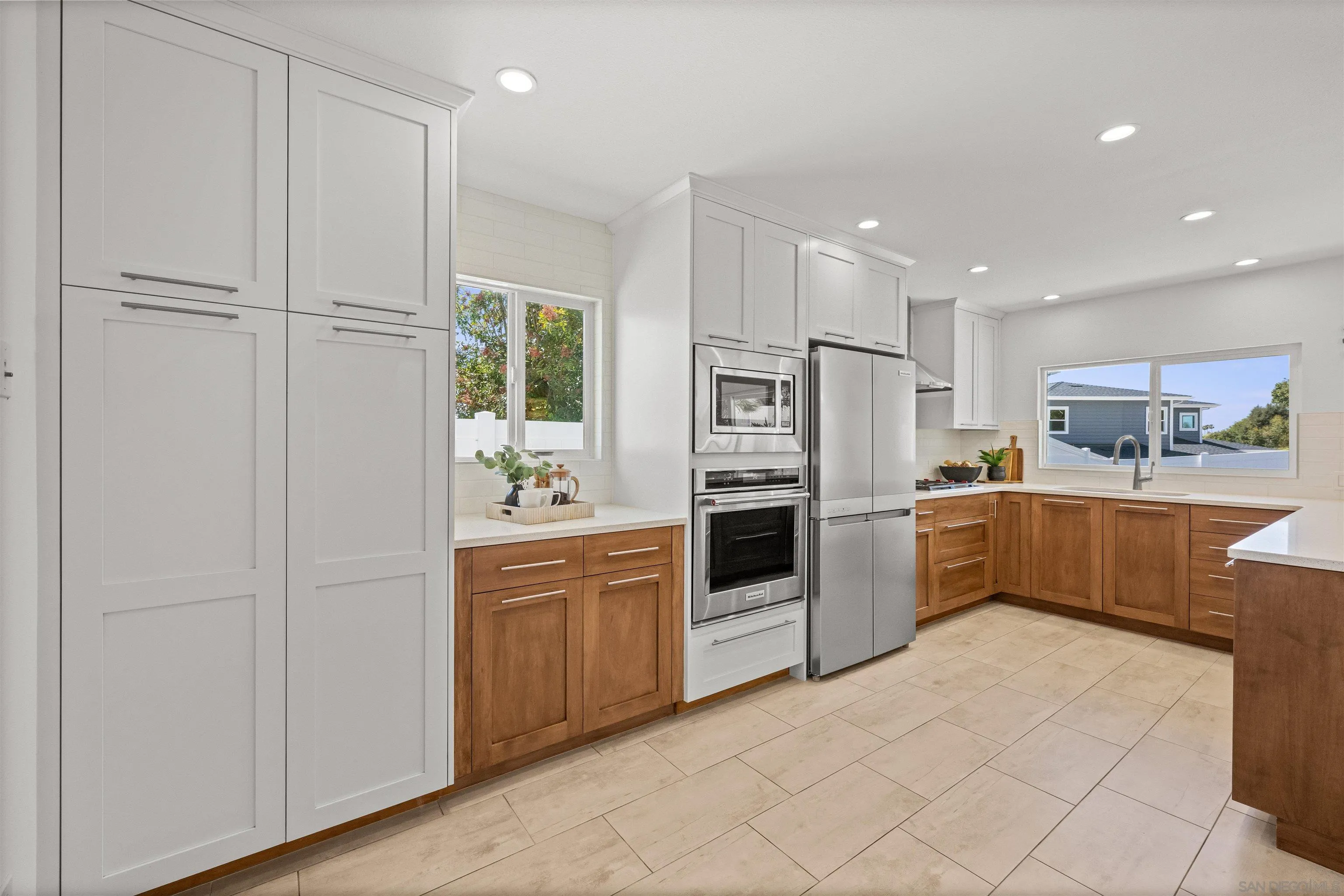 2001 Elevada Street Oceanside, CA 92054 - Photo 13 of 39 a kitchen with white cabinets and stainless steel appliances