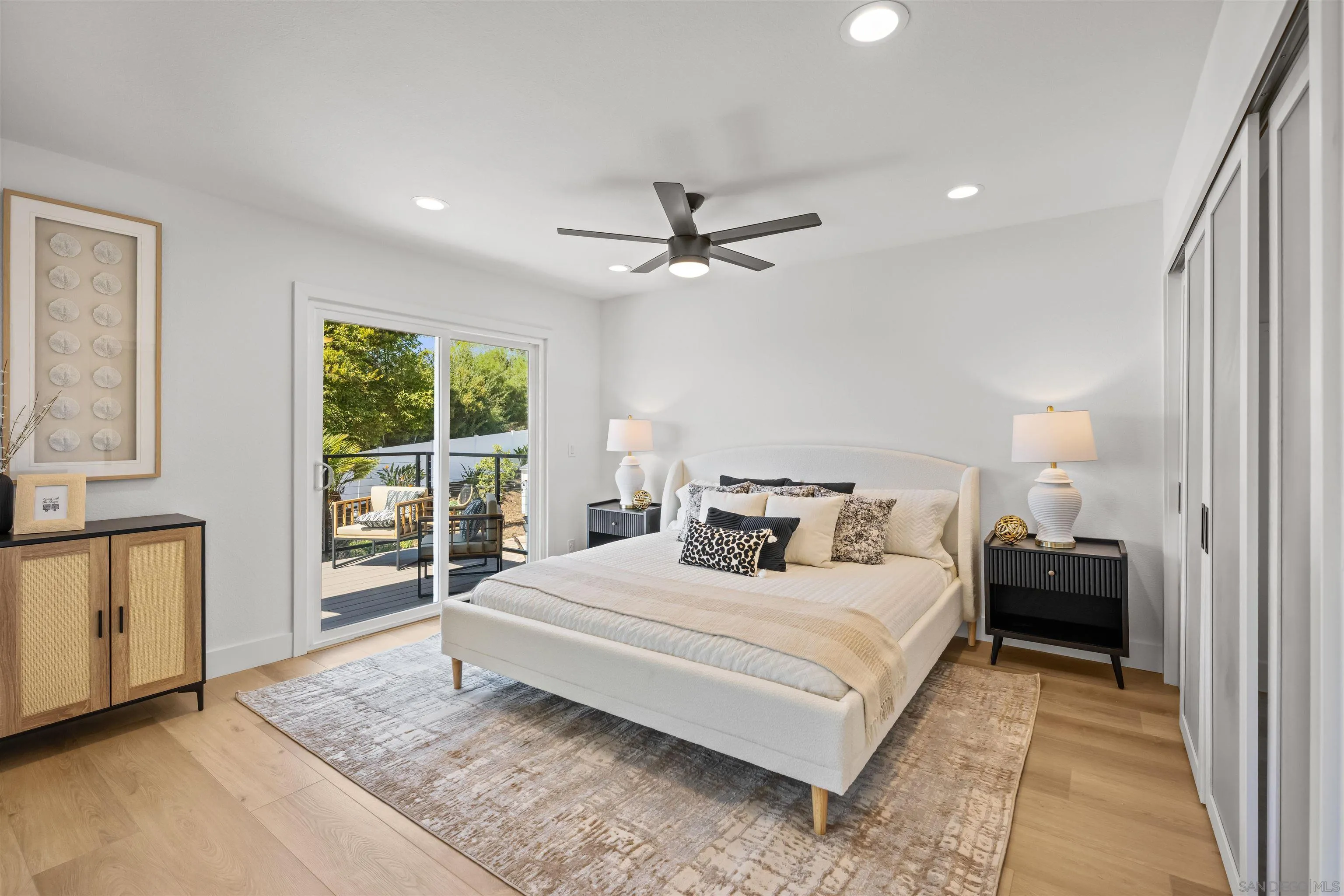 2001 Elevada Street Oceanside, CA 92054 - Photo 15 of 39 a bedroom with a large bed and a chandelier