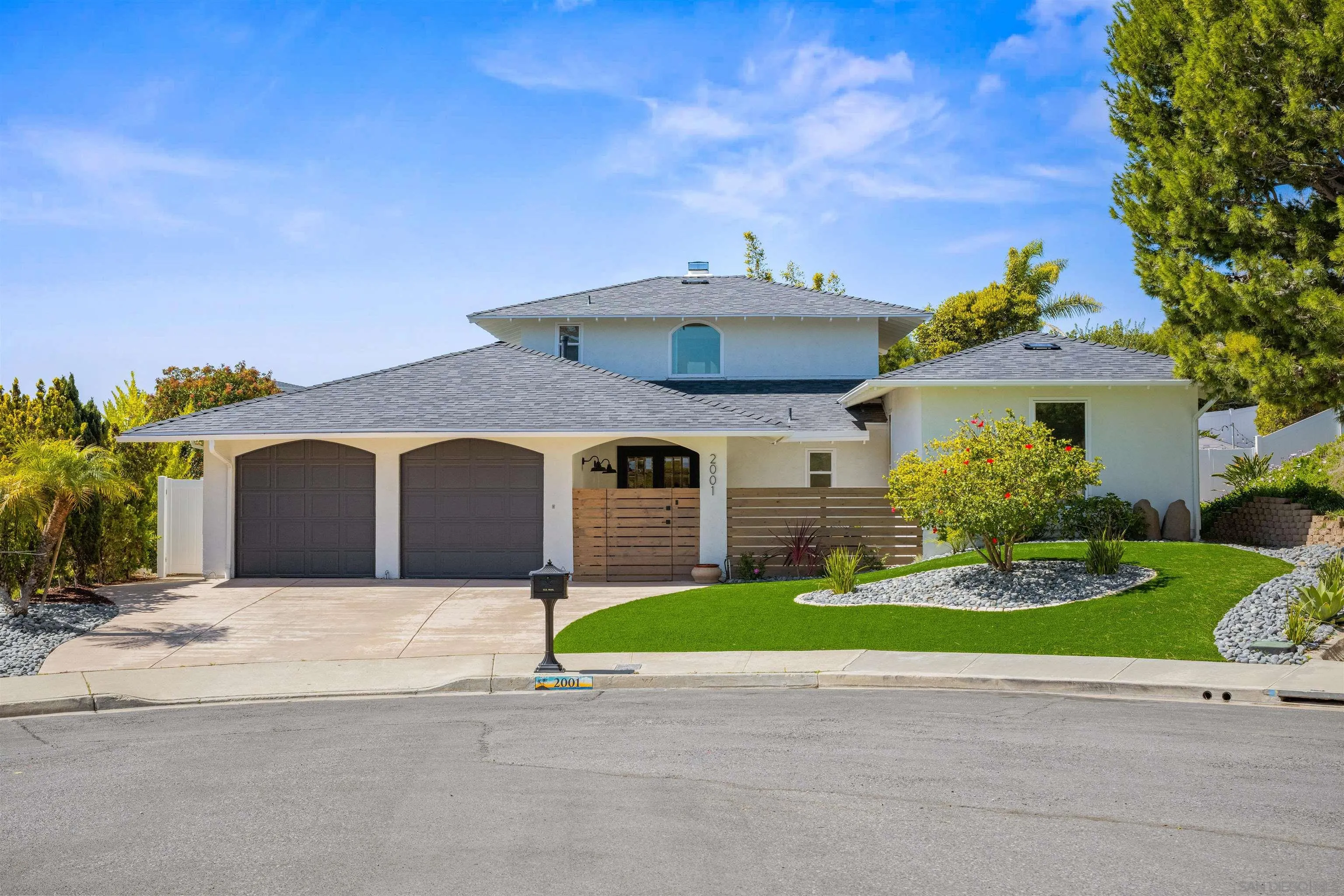 2001 Elevada Street Oceanside, CA 92054 - Photo 2 of 39 a front view of a house with a yard and garage