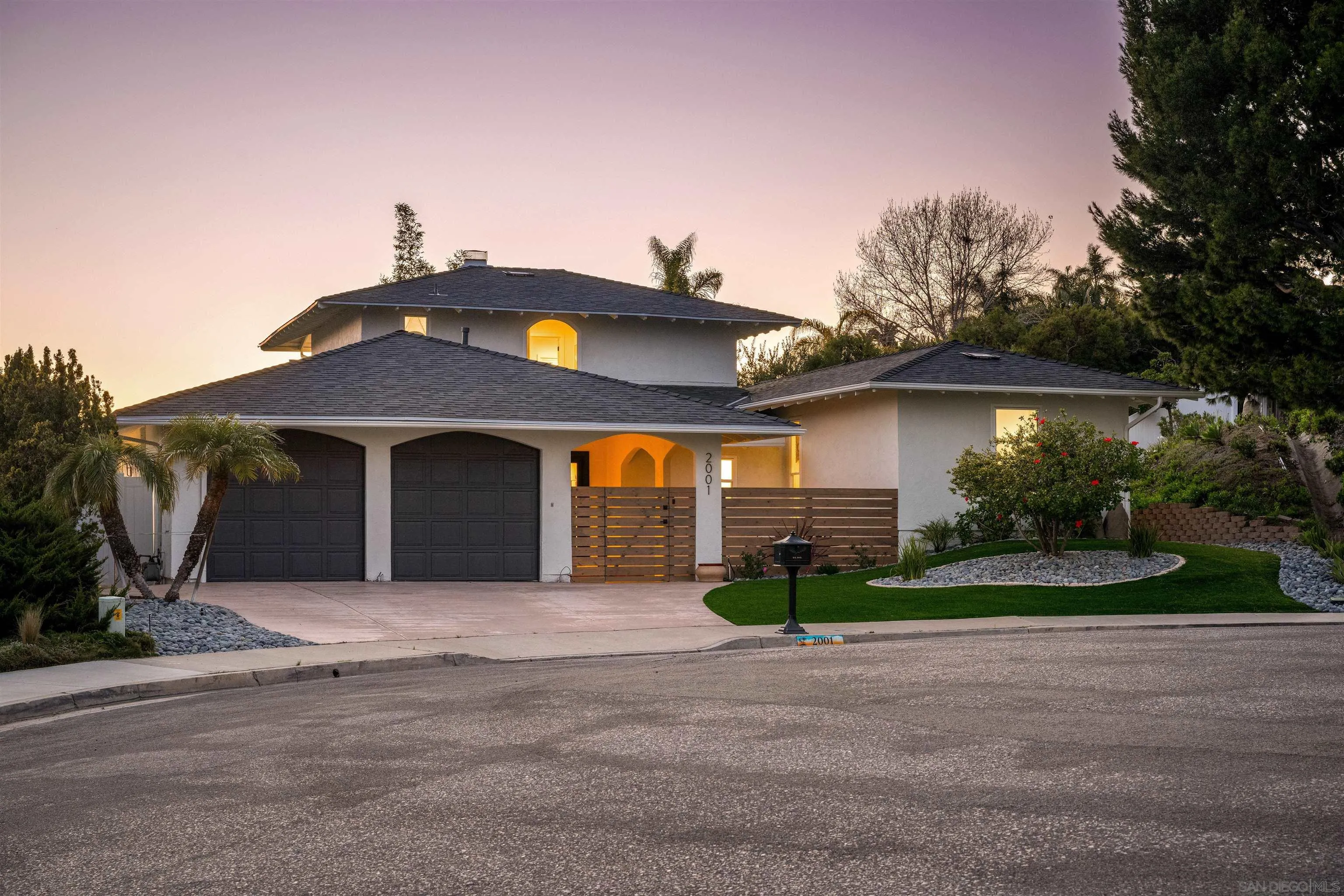 2001 Elevada Street Oceanside, CA 92054 - Photo 27 of 39 a front view of a house with a yard and garage