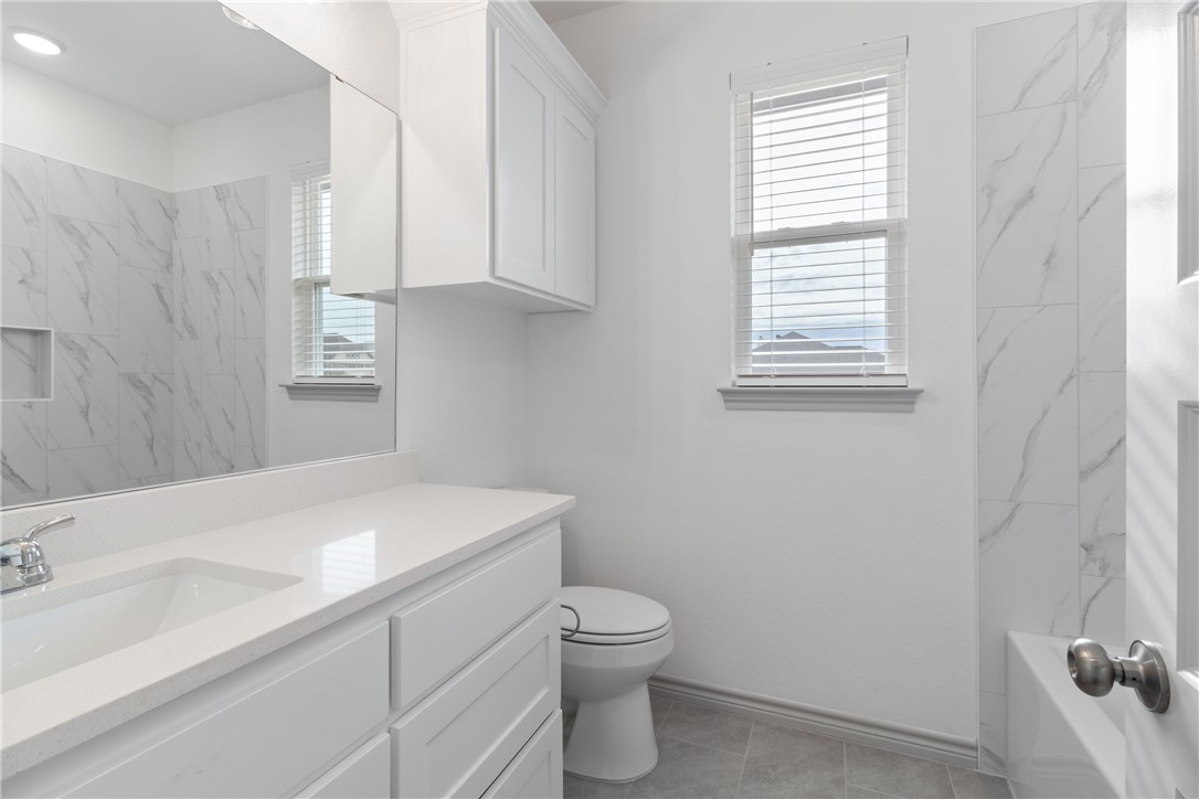 1900 Stubbs Drive Bryan, TX 77807 - Photo 13 of 15 a bathroom with a sink a toilet and a window