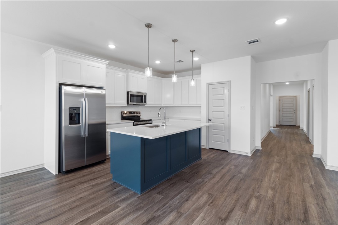 1900 Stubbs Drive Bryan, TX 77807 - Photo 4 of 15 a large kitchen with stainless steel appliances granite countertop a large counter top a sink and a refrigerator