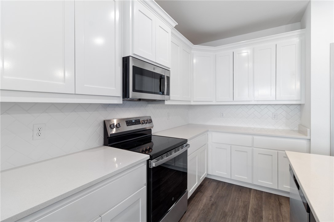 1900 Stubbs Drive Bryan, TX 77807 - Photo 5 of 15 a kitchen with granite countertop white cabinets and white appliances