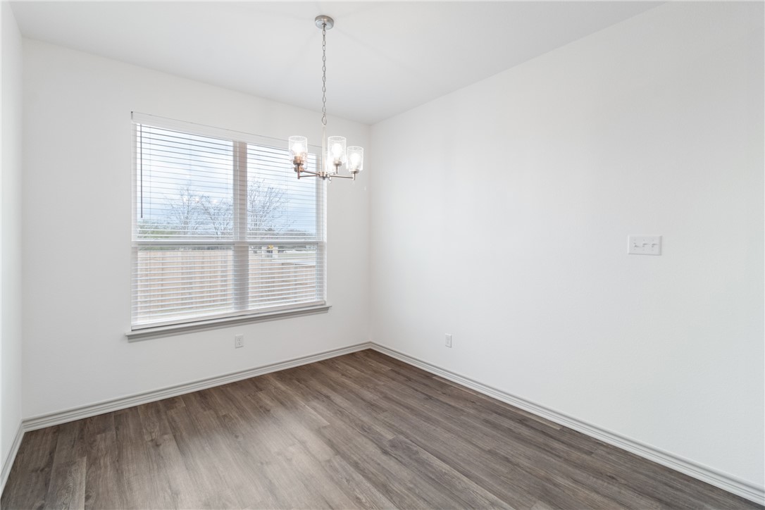 1900 Stubbs Drive Bryan, TX 77807 - Photo 6 of 15 an empty room with wooden floor exposed radiator and windows