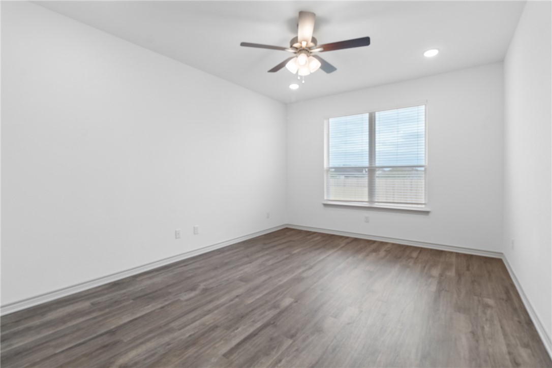 1900 Stubbs Drive Bryan, TX 77807 - Photo 7 of 15 an empty room with wooden floor and windows
