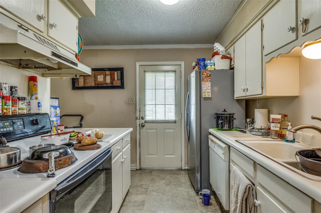 101 Gordon Drive Azle, TX 76020 - Photo 12 of 25 Kitchen with electric range, under cabinet range hood, white dishwasher, light countertops, and a textured ceiling