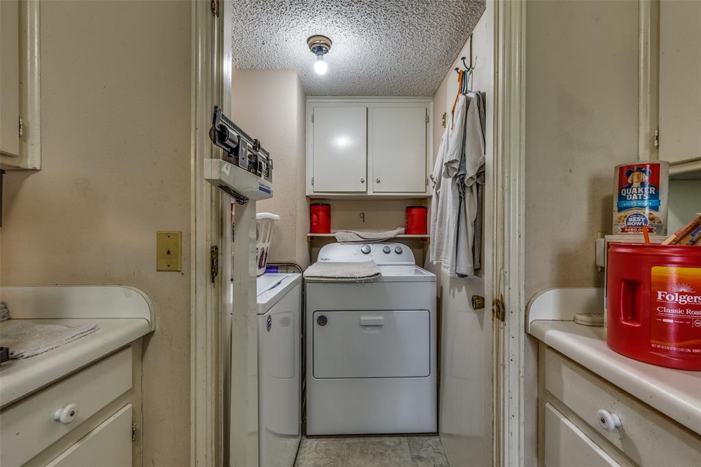 101 Gordon Drive Azle, TX 76020 - Photo 13 of 25 Laundry area with separate washer and dryer, cabinet space, and a textured ceiling