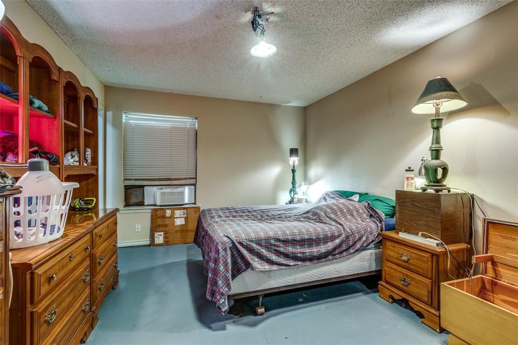 101 Gordon Drive Azle, TX 76020 - Photo 16 of 25 Bedroom featuring a textured ceiling, cooling unit, and concrete floors
