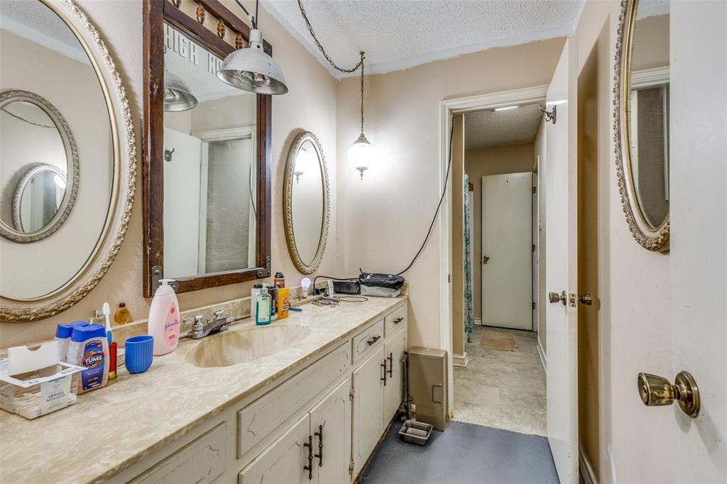 101 Gordon Drive Azle, TX 76020 - Photo 19 of 25 Bathroom featuring a textured ceiling and vanity