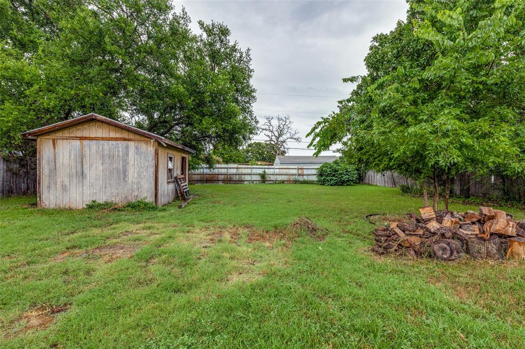 101 Gordon Drive Azle, TX 76020 - Photo 22 of 25 Fenced backyard featuring an outbuilding