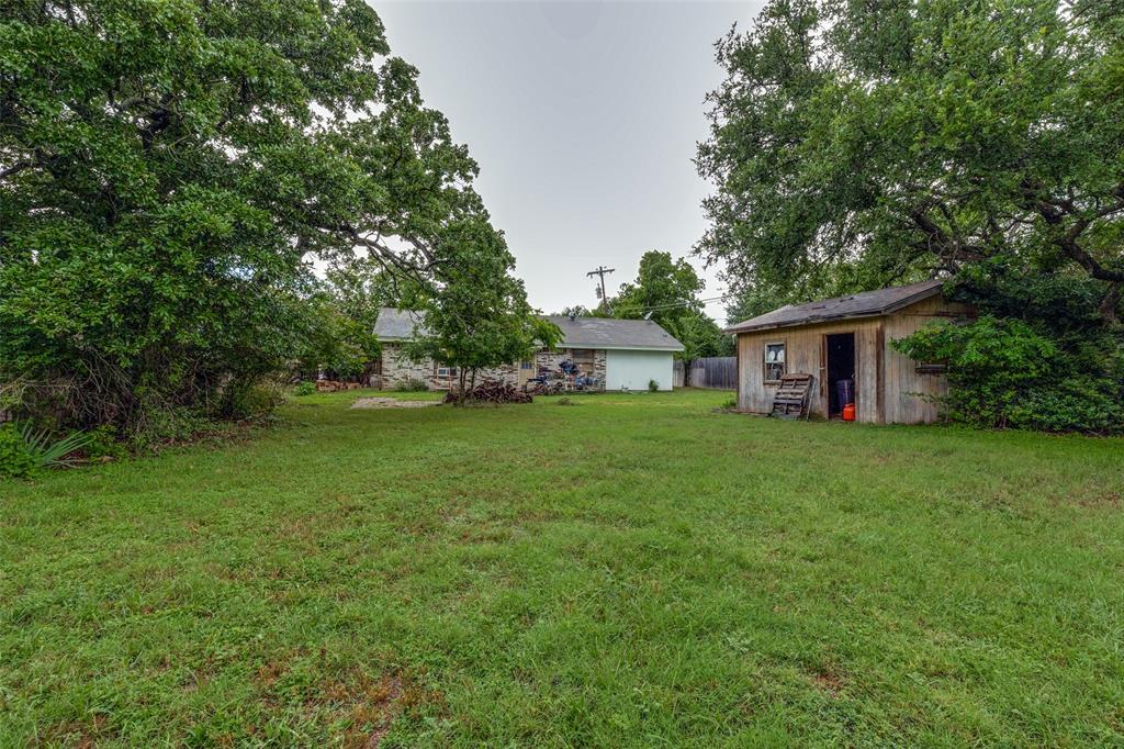 101 Gordon Drive Azle, TX 76020 - Photo 24 of 25 View of grassy yard with an outdoor structure