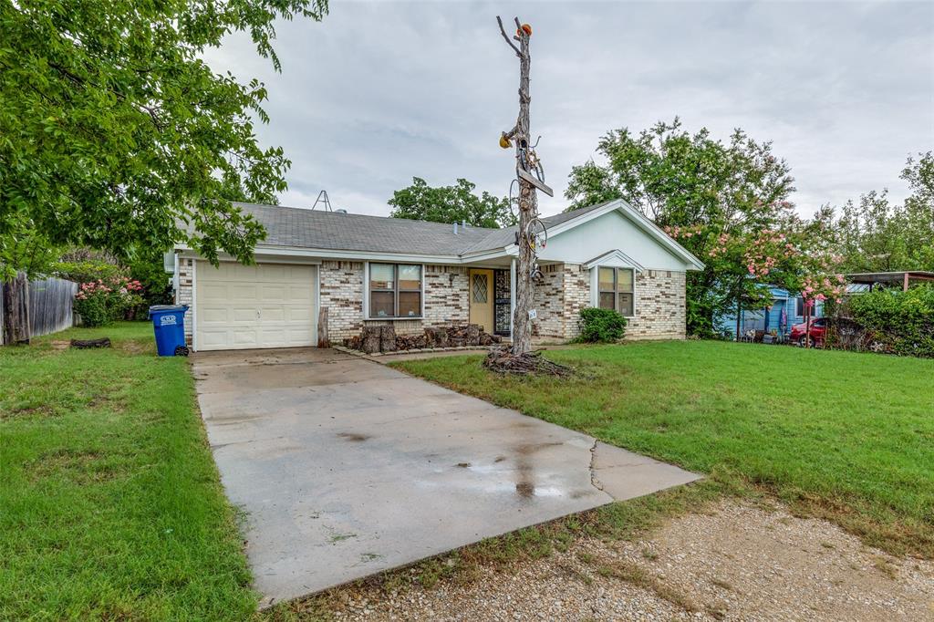101 Gordon Drive Azle, TX 76020 - Photo 3 of 25 Ranch-style house with concrete driveway, a garage, and brick siding