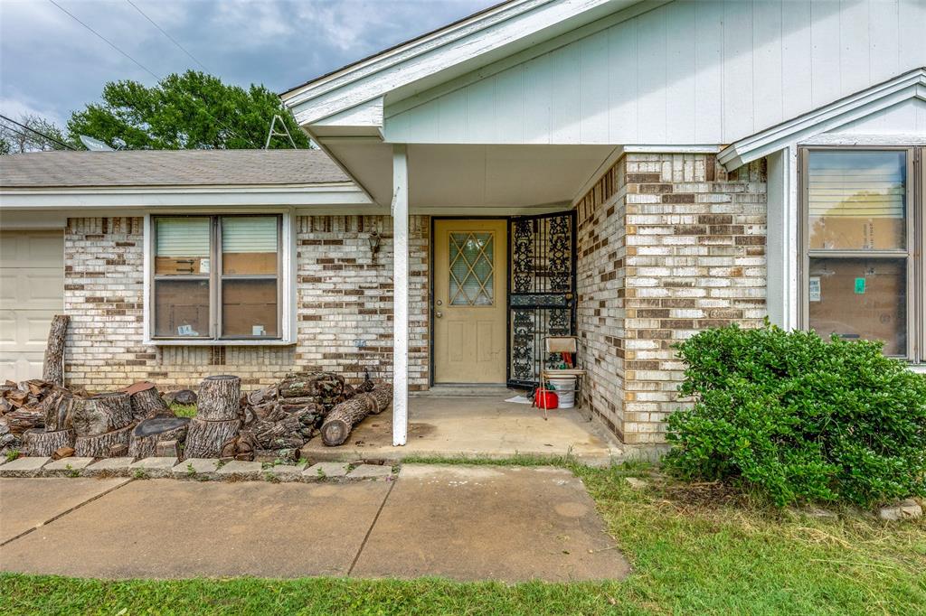 101 Gordon Drive Azle, TX 76020 - Photo 6 of 25 Entrance to property with brick siding and roof with shingles